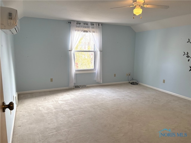 carpeted spare room featuring vaulted ceiling, a wall mounted air conditioner, and ceiling fan