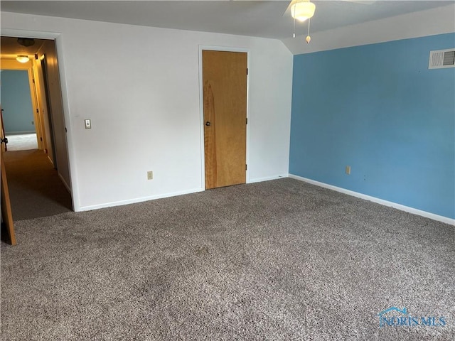 spare room with carpet and lofted ceiling