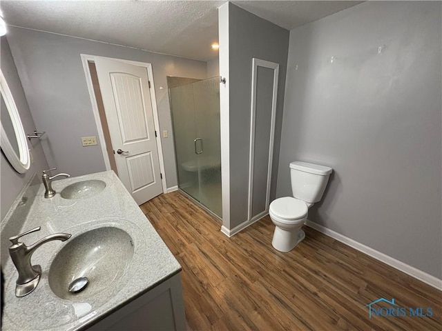 bathroom with walk in shower, vanity, toilet, and hardwood / wood-style flooring