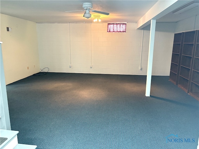 basement featuring ceiling fan and carpet