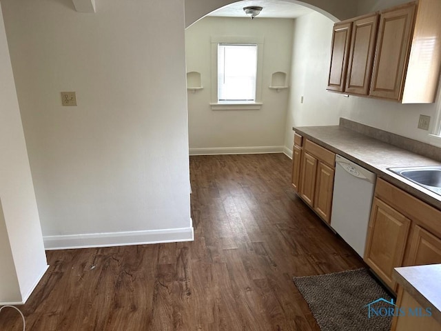 kitchen featuring dark wood-type flooring, dishwasher, and sink