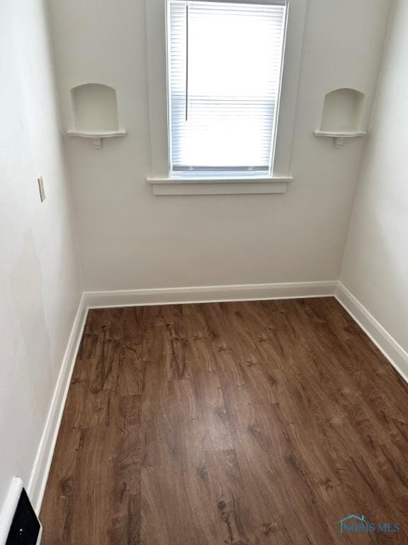 spare room featuring dark hardwood / wood-style flooring