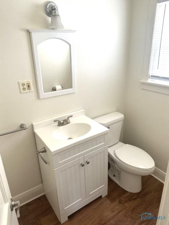 bathroom with vanity, wood-type flooring, and toilet