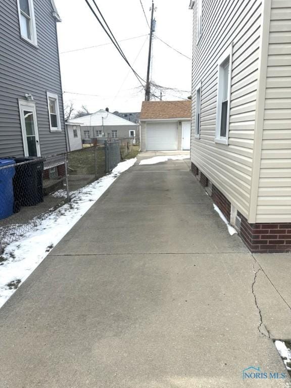 exterior space featuring a garage and an outbuilding