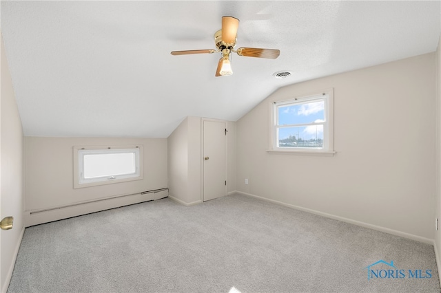 bonus room with a baseboard radiator, lofted ceiling, light colored carpet, and ceiling fan