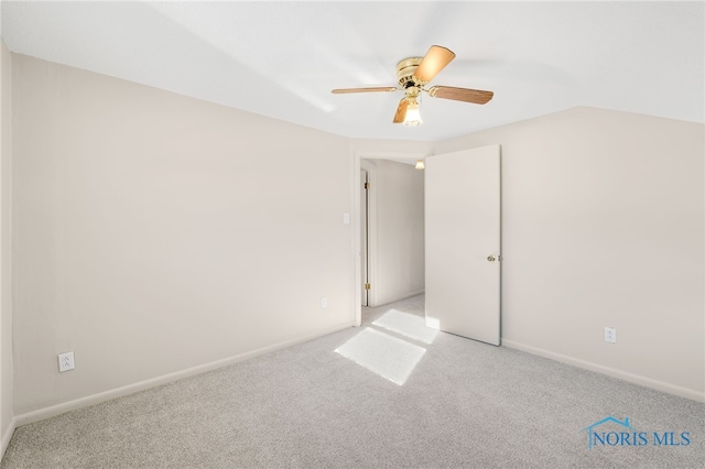 empty room featuring light colored carpet and ceiling fan