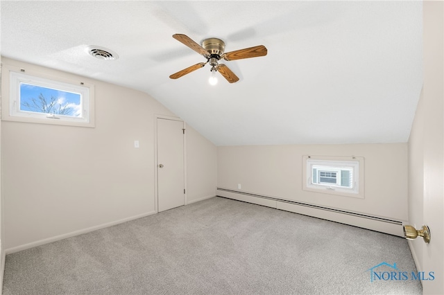 bonus room featuring vaulted ceiling, plenty of natural light, light colored carpet, and baseboard heating