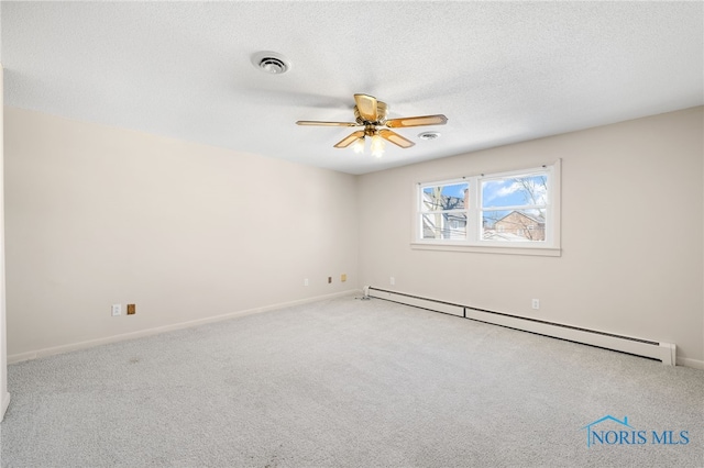 empty room featuring a baseboard heating unit, light colored carpet, a textured ceiling, and ceiling fan