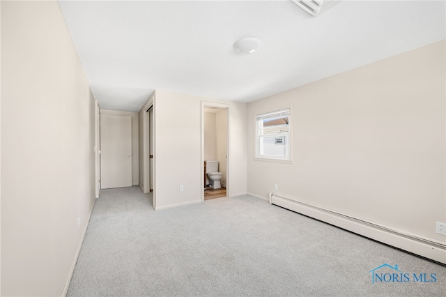 unfurnished bedroom featuring baseboard heating, connected bathroom, and light carpet