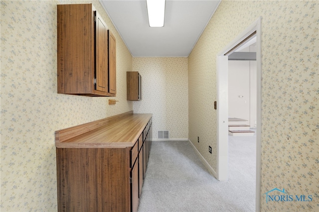 hallway featuring light carpet