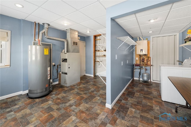 utilities featuring gas water heater, washer and dryer, heating unit, and tankless water heater