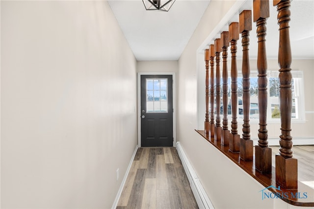 entryway with wood-type flooring and a baseboard radiator