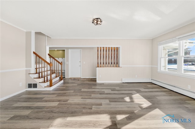 unfurnished living room with crown molding, wood-type flooring, and a baseboard radiator