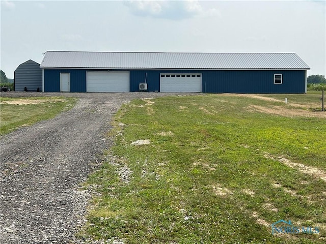 garage featuring a lawn