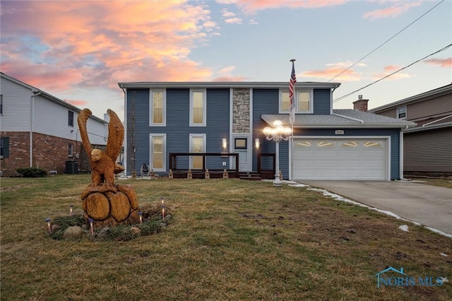 view of front property with a garage and a yard