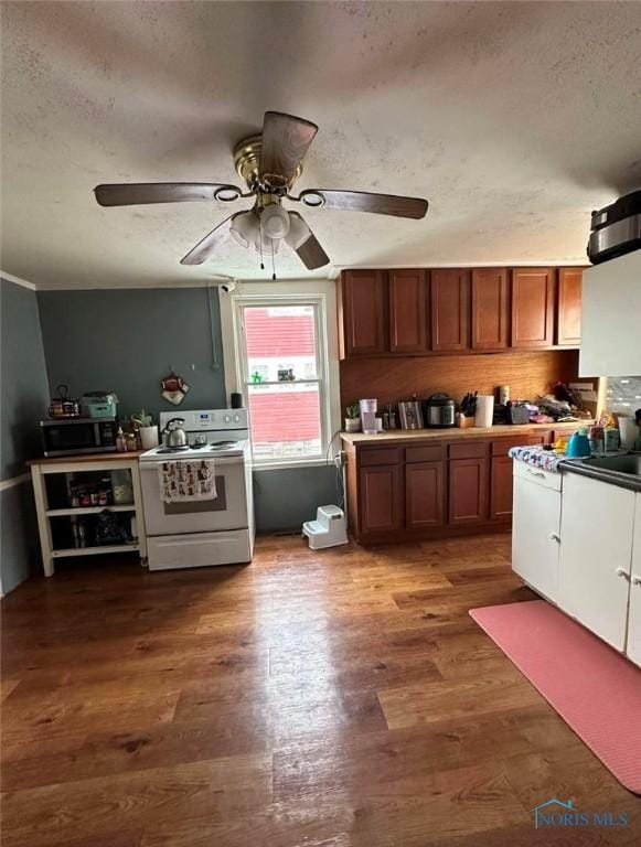 kitchen featuring ceiling fan, dark wood-type flooring, a textured ceiling, and white range with electric stovetop