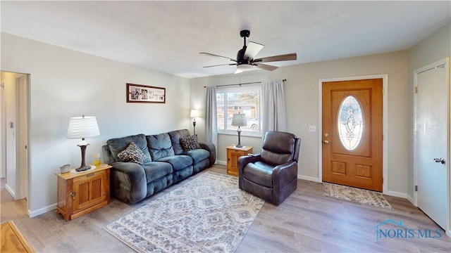 living room with ceiling fan and light hardwood / wood-style floors