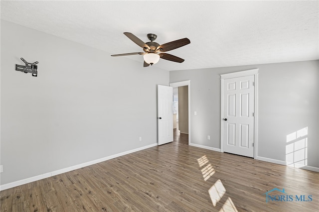 spare room with lofted ceiling, hardwood / wood-style floors, and ceiling fan