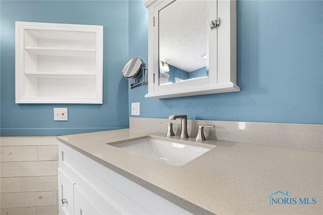 bathroom featuring vanity and a textured ceiling