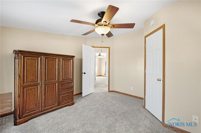 unfurnished bedroom featuring light colored carpet and ceiling fan