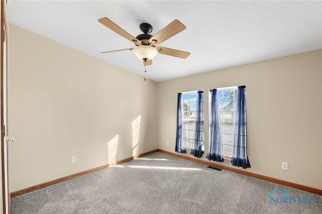 carpeted empty room with ceiling fan