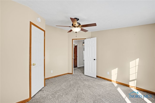 unfurnished bedroom featuring ceiling fan, light colored carpet, and a closet