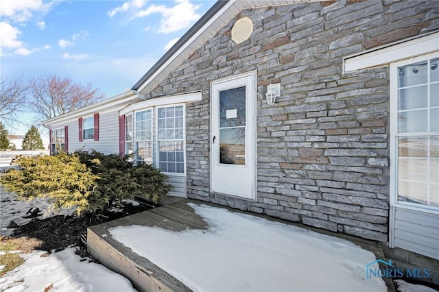 view of snow covered property entrance