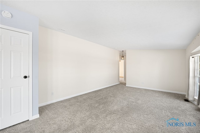 empty room featuring light colored carpet