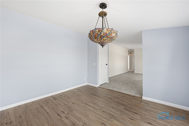 spare room with dark wood-type flooring