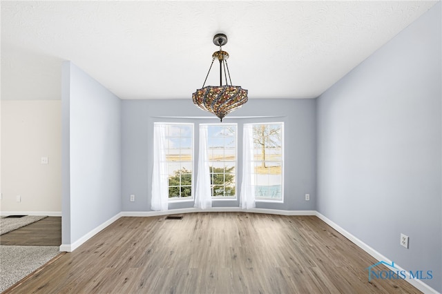 interior space with light hardwood / wood-style floors and a textured ceiling