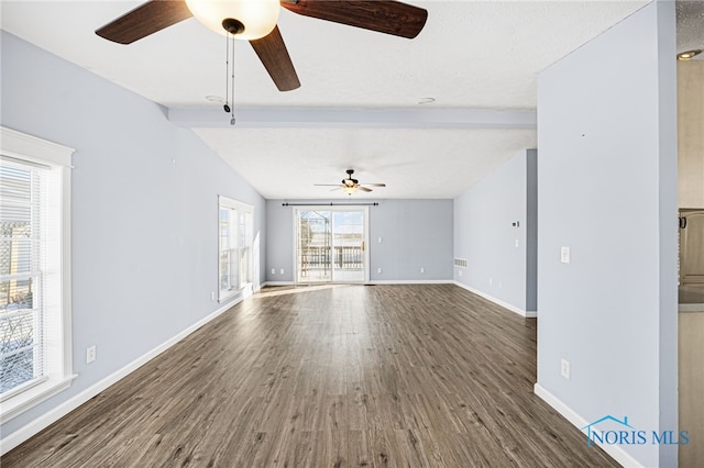 unfurnished living room with ceiling fan, vaulted ceiling with beams, and dark hardwood / wood-style floors