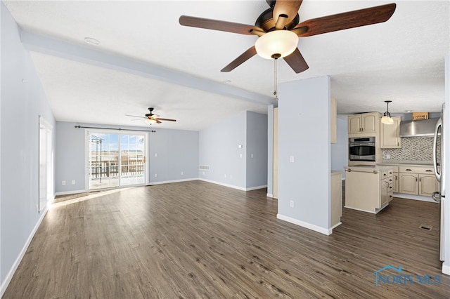 unfurnished living room with dark wood-type flooring, ceiling fan, and beamed ceiling