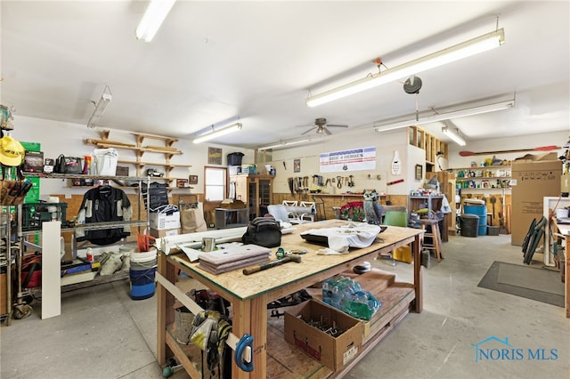 garage with ceiling fan and a workshop area