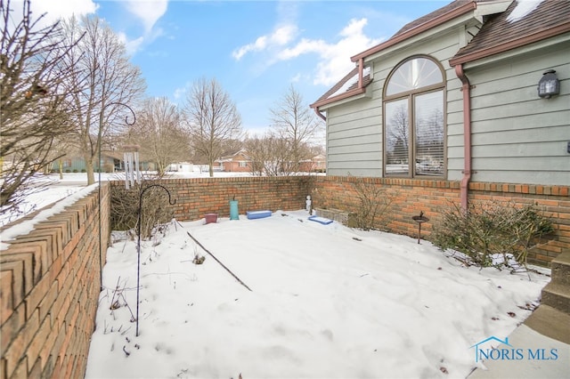 view of yard layered in snow