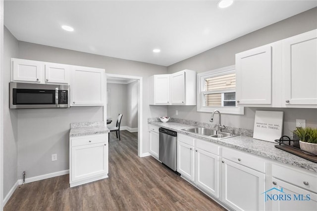 kitchen with white cabinetry, stainless steel appliances, and sink