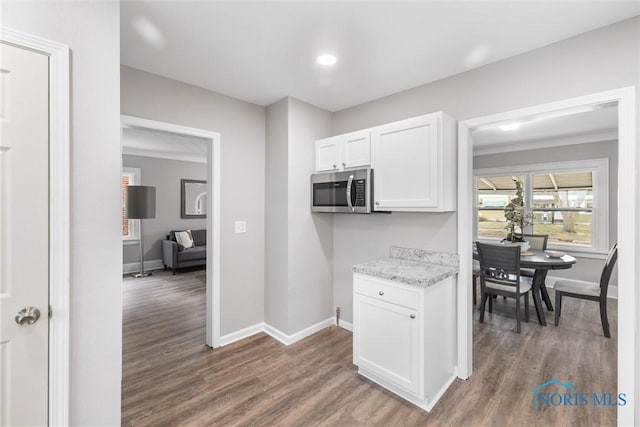 kitchen with white cabinets and dark hardwood / wood-style flooring