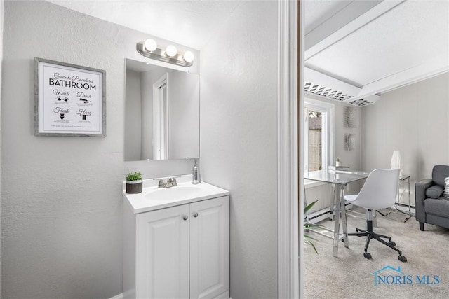 bathroom featuring a baseboard radiator and vanity