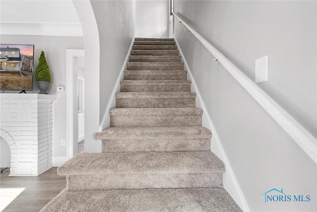 stairs with hardwood / wood-style flooring