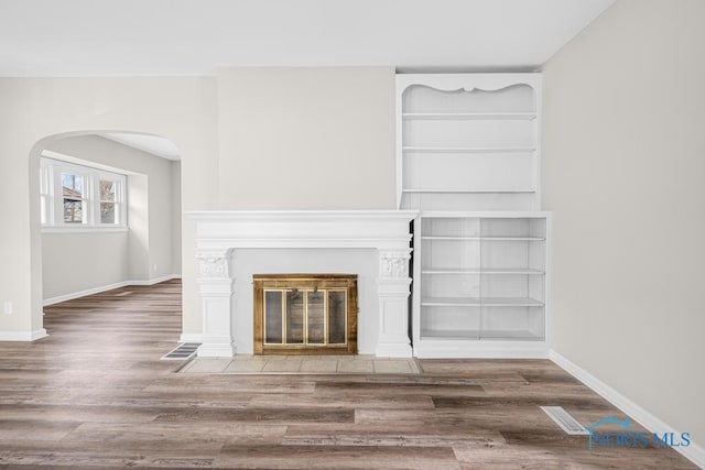 unfurnished living room featuring wood-type flooring