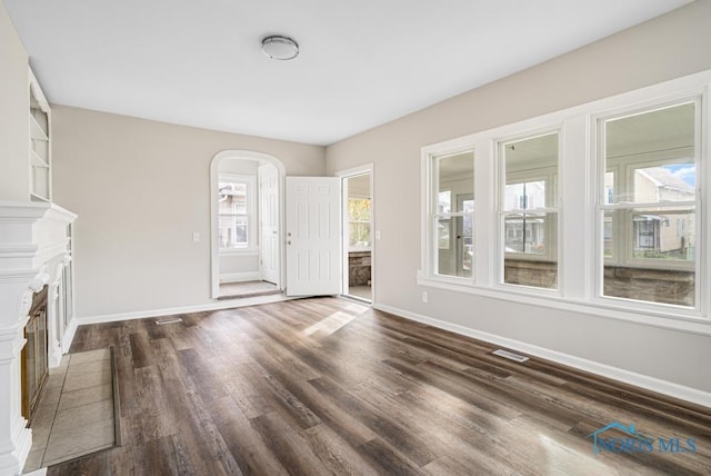 unfurnished living room featuring dark hardwood / wood-style floors