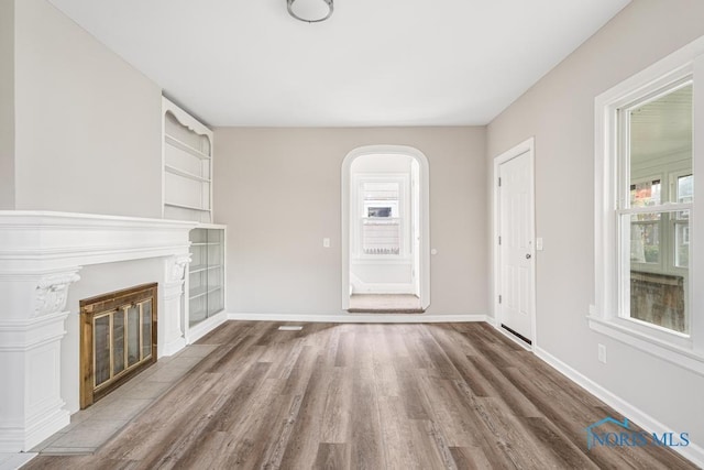 unfurnished living room with hardwood / wood-style floors