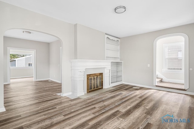 unfurnished living room with hardwood / wood-style floors