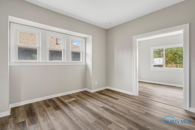 unfurnished room featuring hardwood / wood-style floors