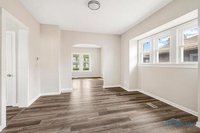 empty room featuring dark wood-type flooring