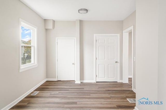 unfurnished bedroom with wood-type flooring