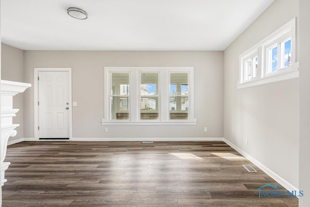 unfurnished living room featuring dark hardwood / wood-style floors