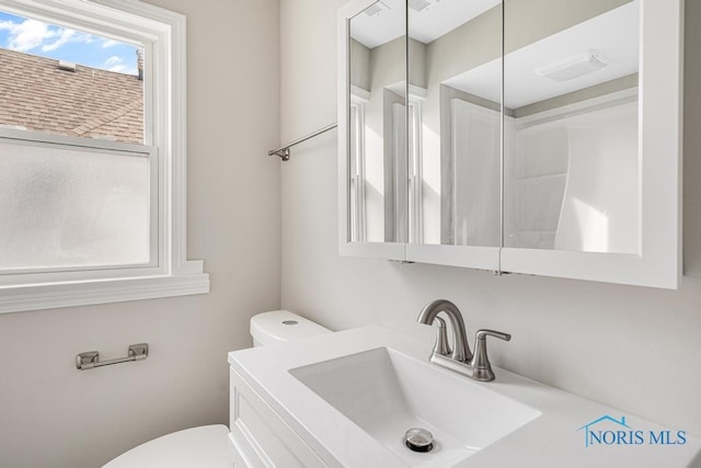 bathroom featuring vanity and toilet