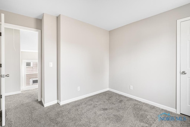 unfurnished room with light carpet