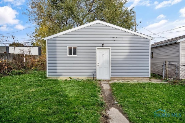 view of outbuilding with a lawn