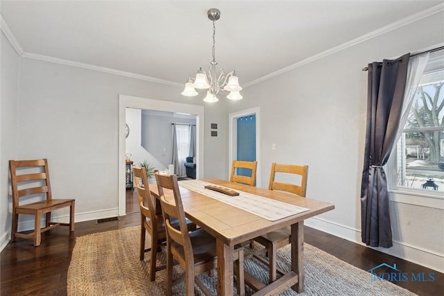 dining room featuring crown molding and dark hardwood / wood-style flooring